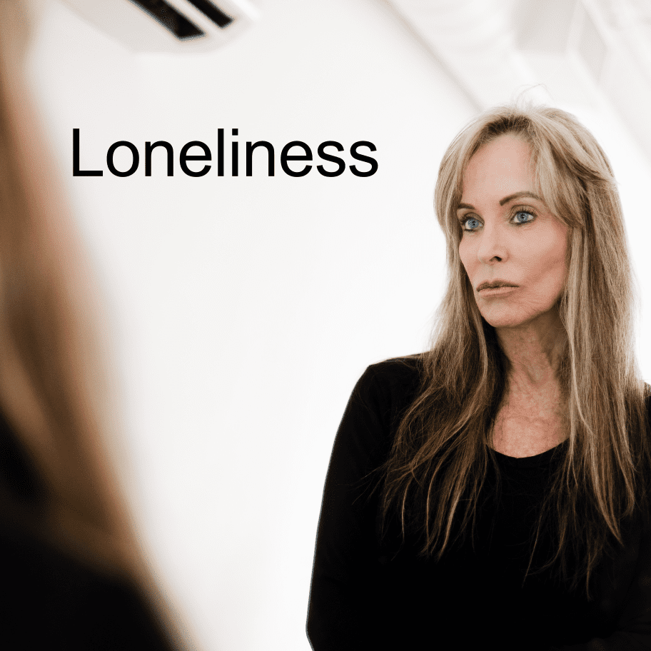 A woman standing in front of a mirror with the word loneliness written underneath her.